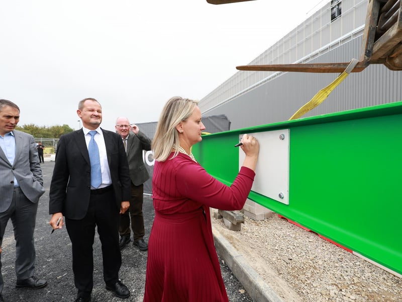 Kelly Becker signs the girder