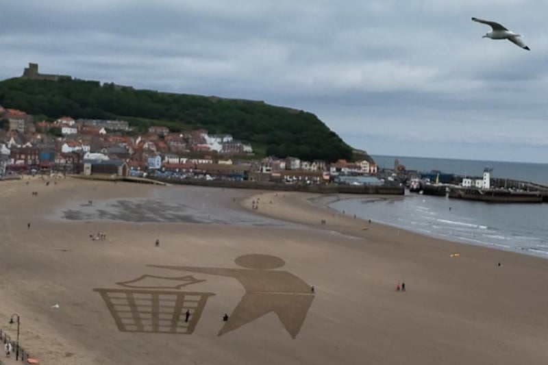Beach artwork urging people to keep Scarborough's beaches litter-free, by Peter Robinson.