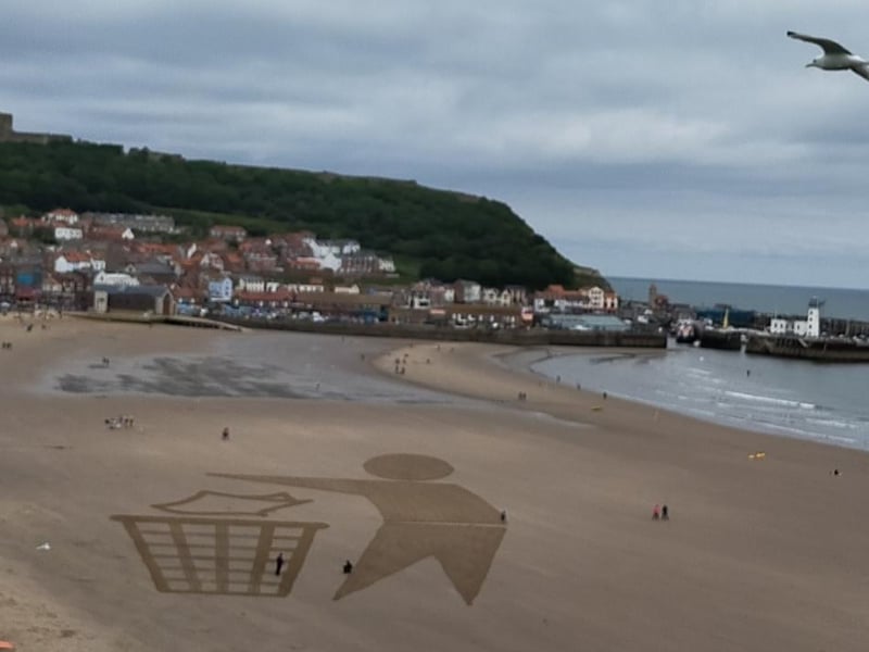 Beach artwork urging people to keep Scarborough's beaches litter-free, by Peter Robinson.