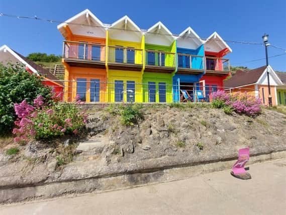 Brightly coloured beach chalets are up for grabs with price tags of £70,000 up.