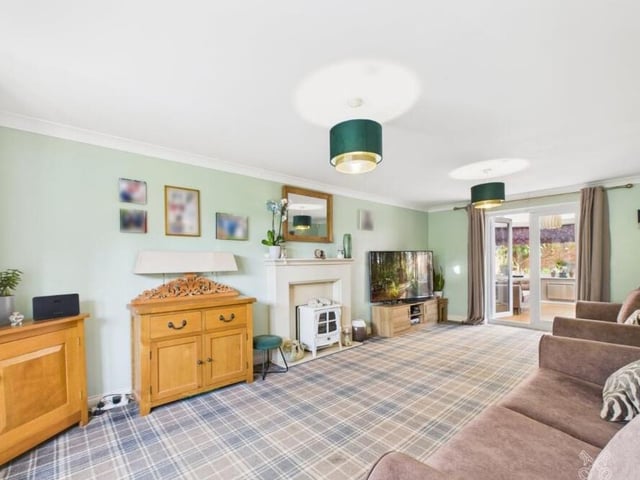 A large reception room with feature fireplace.