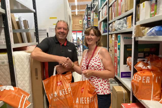 Argos store manager Jono Paulson presenting the food donation to Mel Tilley, one of Foodbank4Whitby trustees.