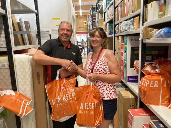 Argos store manager Jono Paulson presenting the food donation to Mel Tilley, one of Foodbank4Whitby trustees.