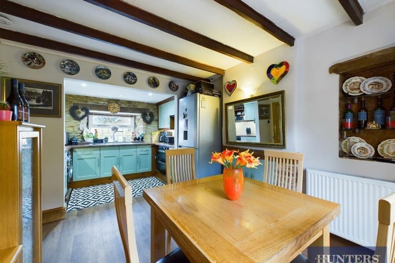 The beamed dining area links to the kitchen.