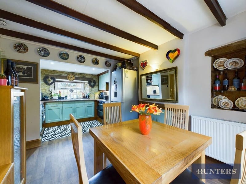 The beamed dining area links to the kitchen.