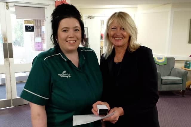 Ebony Colman,Care Assistant, being presented her 10 year service award by Diane Peters, General Manager. Photo submitted.