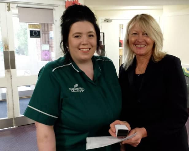Ebony Colman,Care Assistant, being presented her 10 year service award by Diane Peters, General Manager. Photo submitted.