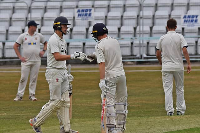 Scarborough CC batsmen Ben Squires and Danny O'Connor celebrate their 100-run stand. Photo by Simon Dobson