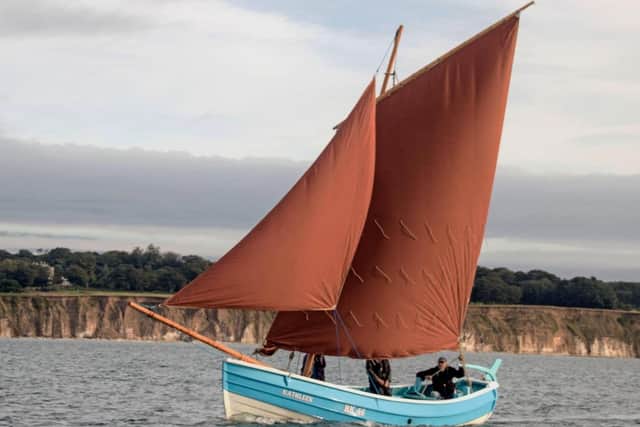 The restored coble Kathleen under sail.