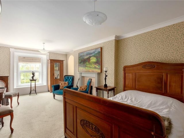 A spacious double bedroom, with fireplace feature.