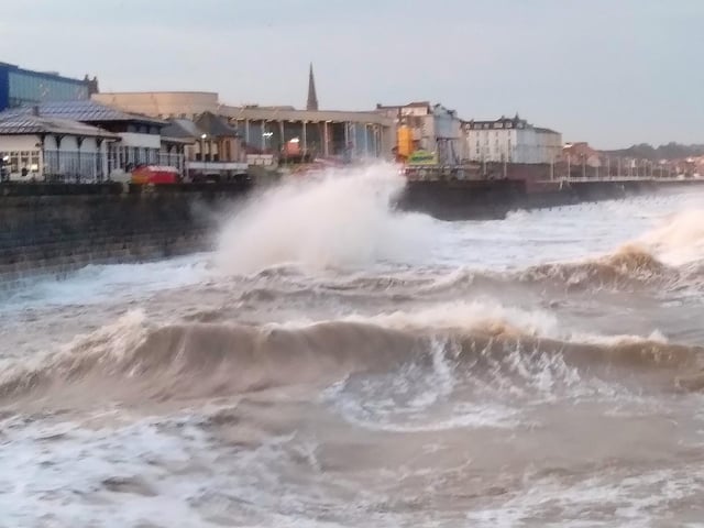Alan Flynn concentrates on choppy waves as they hit the seafront wall.