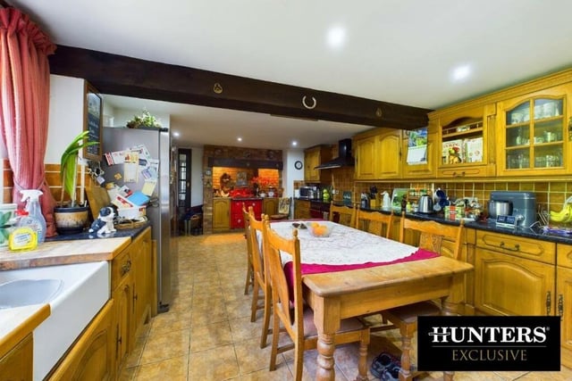 The traditional style dining kitchen has allocated space for a range-style cooker.