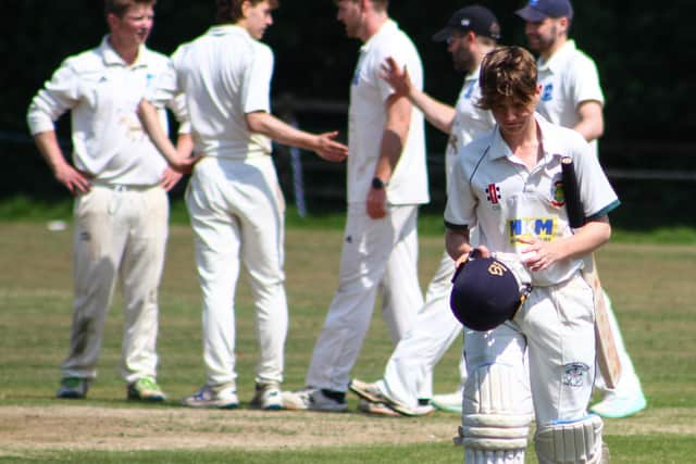 A Flixton 2nds batter trudges off while the Scalby fielders celebrate.