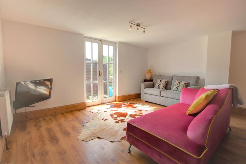 The apartment sitting room has French doors out to a patio area.