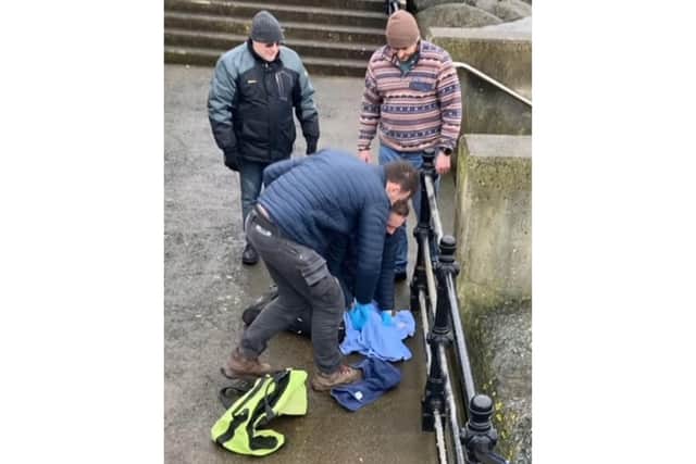 Todd German and Jordan Woodhead worked quickly to free the pup
