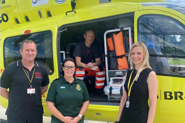 HR Manager Laura Wilson with Yorkshire Air Ambulance, Armed Forces veterans, Pilot, Owen McTeggart (left), Paramedic, Fiona Blaylock (Middle), Paramedic Andrew Armitage (Inside Helicopter).