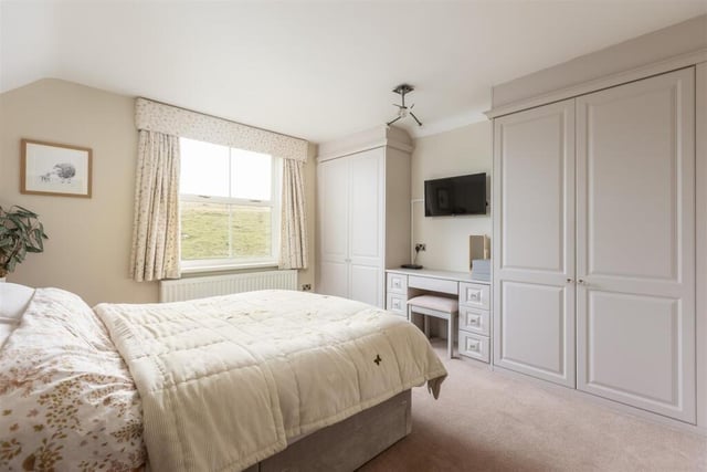 A double bedroom with fitted furniture.