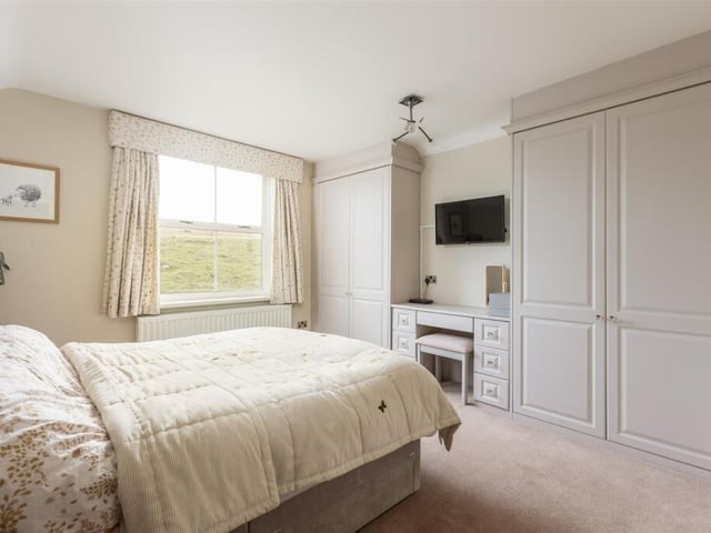 A double bedroom with fitted furniture.