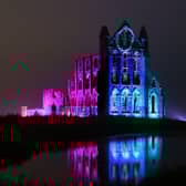 English Heritage lights up the ruins of iconic site Whitby Abbey in North Yorkshire for Illuminated Abbey 2023.