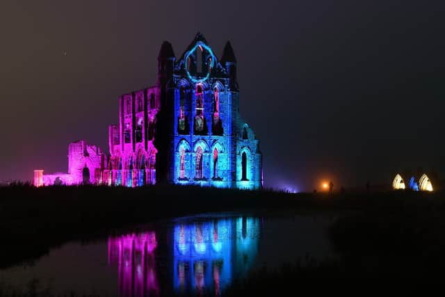 English Heritage lights up the ruins of iconic site Whitby Abbey in North Yorkshire for Illuminated Abbey 2023.