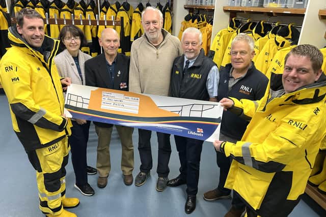 Whitby RNLI crew accept a cheque from Facing the Waves Director Antony Bellekom. picture: RNLI/Ceri Oakes