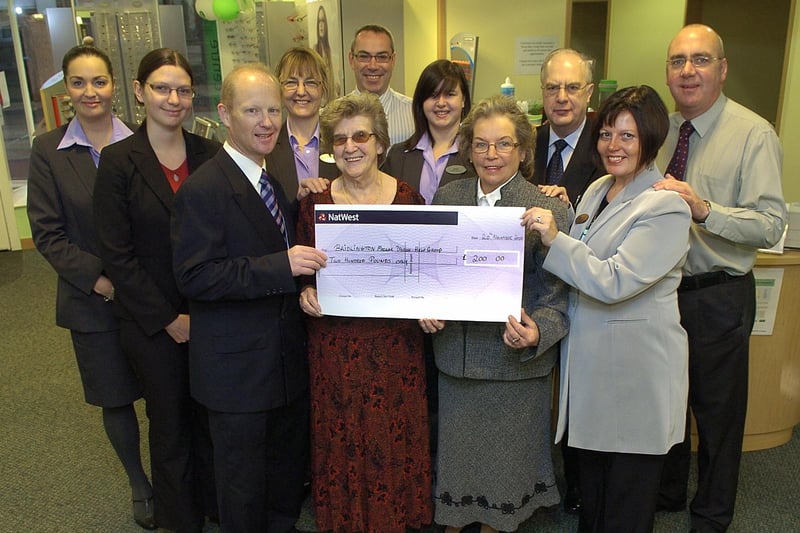 Specsavers staff present a cheque to the Bridlington Macular Disease Help Group. (PA0747-4)