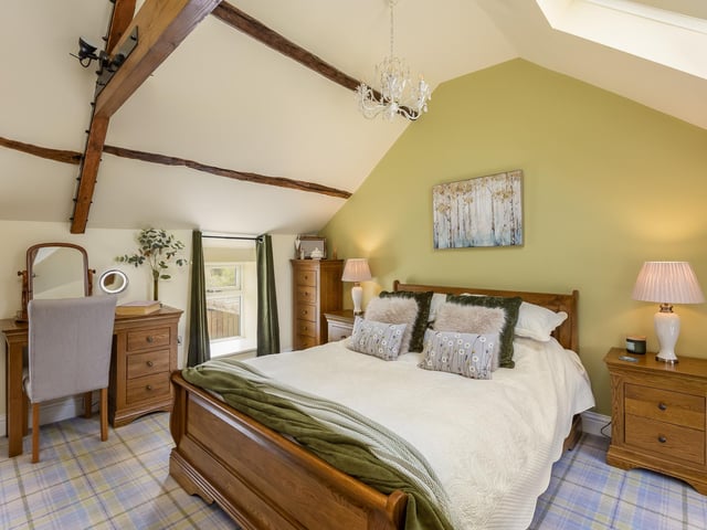 Another charming bedroom, with ceiling beams.