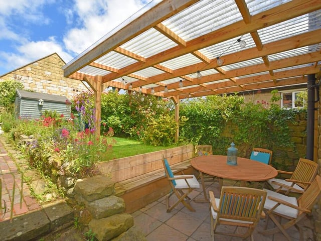 A lovely cottage garden with sheltered seating patio.