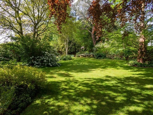 Private lawned gardens are fringed with a variety of trees and shrubs.