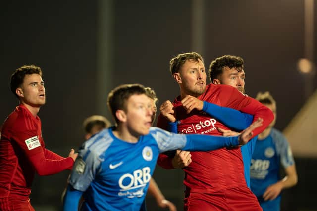 A Yarm & Eaglescliffe player gets to grips with Boro striker Richie Bennett. Photo by Wandering Photography