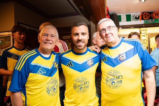 Boro player Michael Duckworth, centre, and a couple of fans, show off the new away team shirt, sponsored by Scholar's Bar.
