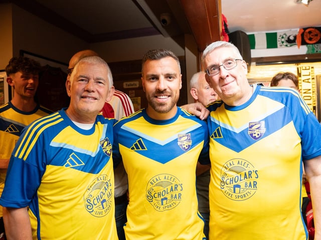 Boro player Michael Duckworth, centre, and a couple of fans, show off the new away team shirt, sponsored by Scholar's Bar.