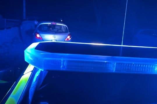 A police officer conducting a stop check.