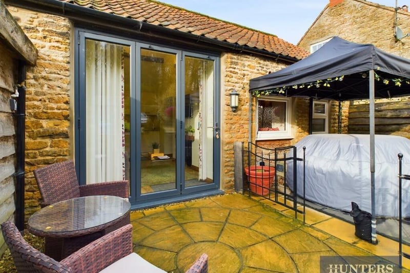 The holiday cottage patio with hot tub area.