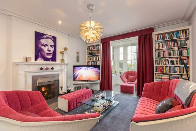 The library with its lovely fireplace, fitted bookshelves and glazed reading room with views over the grounds.