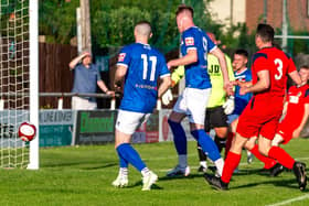 Jerome Greaves scores the opening goal for Whitby Town. PHOTOS BY BRIAN MURFIELD