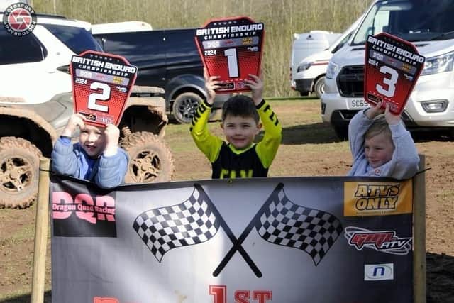 Five-year-old Frankie Robinson, centre, celebrates winning at the British Quad XC Championship.