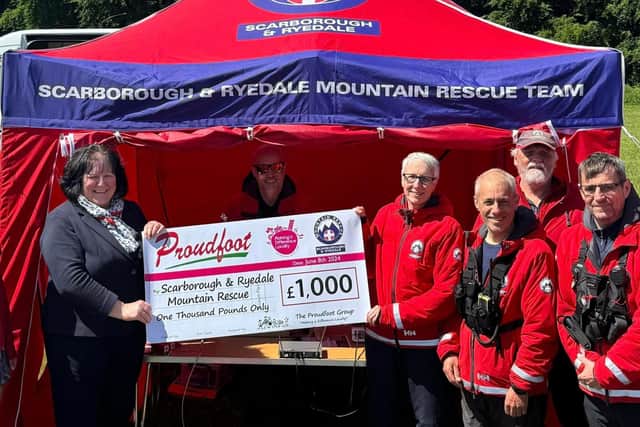 Proudfoot director Valerie Aston presents Scarborough and Ryedale Mountain Rescue Team with a cheque for £1000 - Image: SRMRT