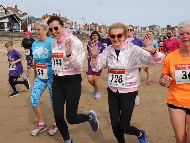 A quick wave to the photographer at the Bridlington Beach 5k.
