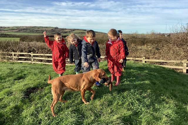 Oakridge School youngsters with Whisper, a specially trained therapy dog.
