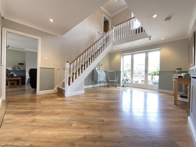 A bright and spacious hallway with staircase leading up.