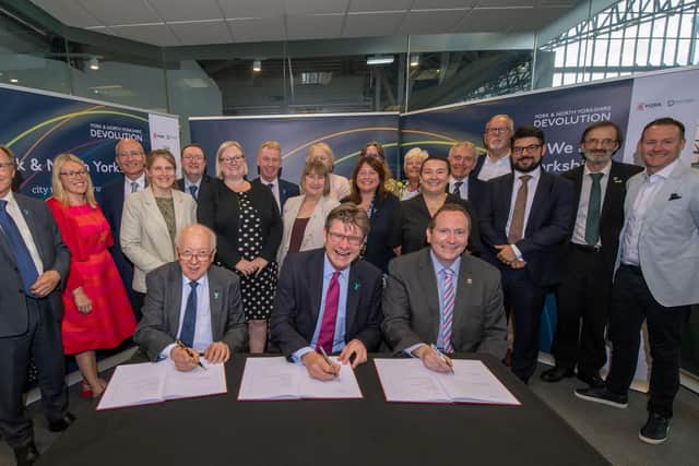 North Yorkshire County Council’s leader Carl Les (left), the Secretary of State for Levelling Up, Housing and Communities Greg Clark (centre) and City of York Council’s leader Keith Aspden (right) with signed copies of the proposed devolution deal at the National Railway Museum in York.