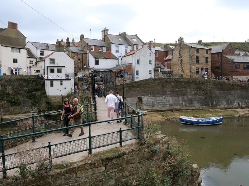 Visitors to Staithes Art Festival taking a stroll around the village.
