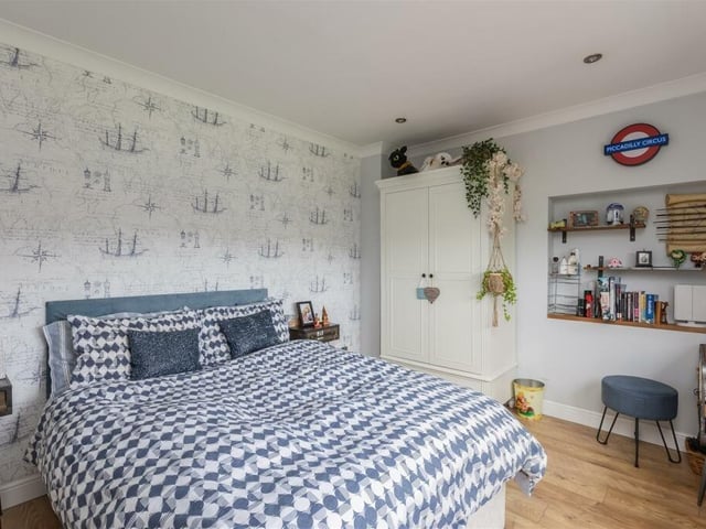 A double bedroom with shelving within the village home.