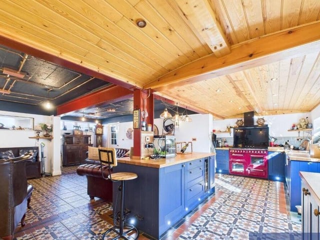 The stylish kitchen with living space is divided by a large island unit.