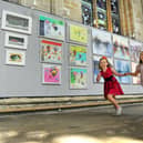 Sisters  Scarlett  and Siena Williams from Bishop Monkton next to some of the art being hung for the Great North Art Show at Ripon Cathedral