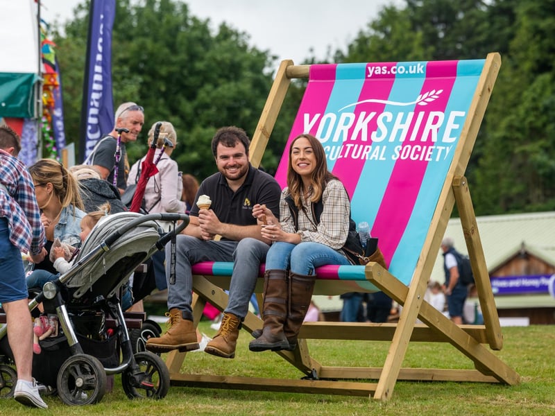 Elliot Moulson and Stephaine Cox taking a break from walking around the show by enjoying an ice cream sat on a giant deck chair