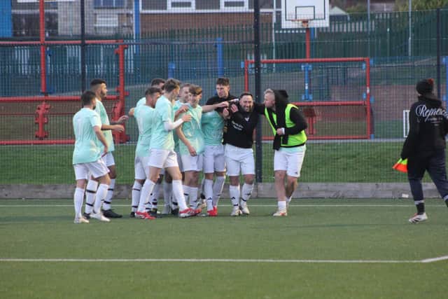 Edgehill celebrate with goalscorer Theo Watson after his goal during their 4-1 home win against Filey Town on Saturday afternoon.