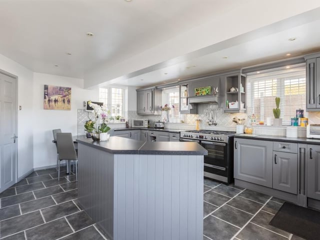 A modern family breakfast kitchen with fitted units and integrated appliances.