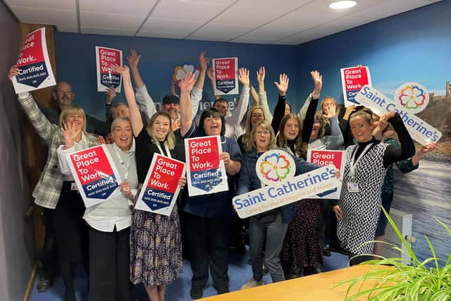 Saint Catherine's staff and volunteers celebrate the Great Place to Work accreditation.